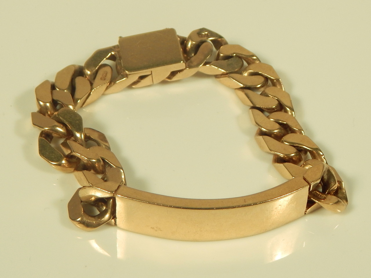 A 9ct gold curb link identity bracelet, 74.7g all in.