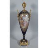 A late 19thC Sevres style two handled urn, with gilt metal mounts, decorated with Watteauesque