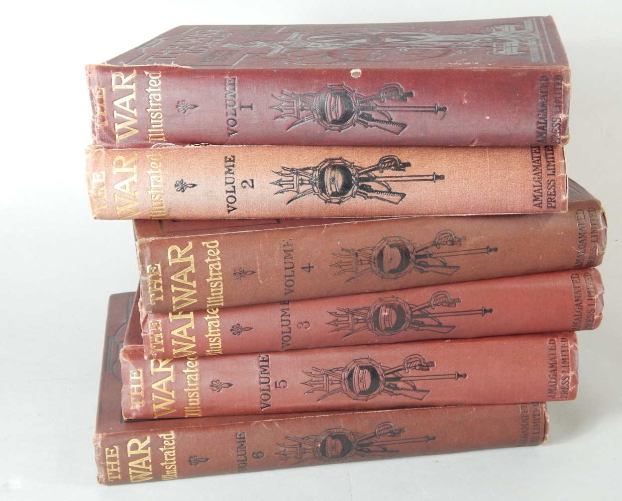 Six volumes of The War Illustrated, with red canvas bindings.