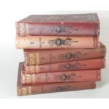 Six volumes of The War Illustrated, with red canvas bindings.