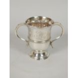 A George III silver loving cup, with scrolling handles and moulded bands on domed foot, engraved