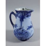 A Macintyre & Co Florian ware jug, designed by William Moorcroft, decorated in pale and navy blue