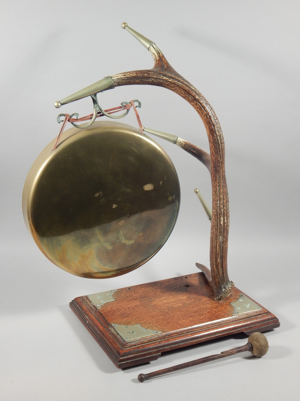 An unusual oak and brass table gong, with antler support and silver plated mounts, the base 35cm