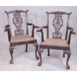 A pair of 19thC Irish mahogany open armchairs, each with a pierced ribbon carved splat and leaf