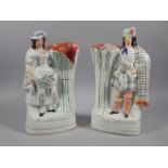 A pair of mid 19thC Staffordshire flatback spill vases, each in the form of a Scotsman and lady,