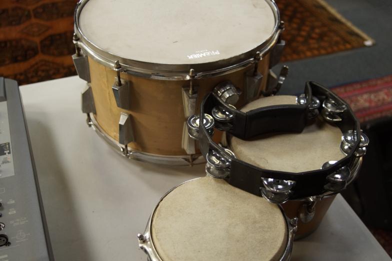 An Aria 14" snare drum, with a pair of percussion plus bongos and tambourine.
