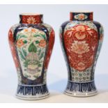 A pair of 20thC Japanese Imari vases, the shouldered bodies decorated with panels of flowers, in