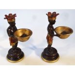 A pair of 19thC style open salts, formed as Native figures with arms out stretched holding bowls, on