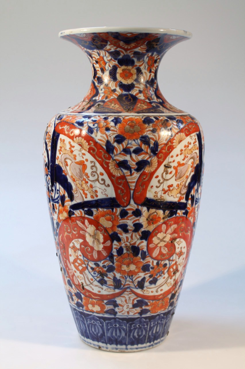 A 19thC Japanese Imari earthenware vase, floor standing with a squat trumpet stem and tapering