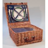 A modern picnic hamper, the hinged lid revealing a fitted interior containing plates, cutlery,