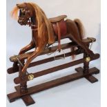 A Peverel Sapp hand made mahogany rocking horse, with leather saddle and horsehair mane and tail,