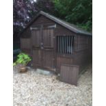 A wooden dog kennel, with separate compartments for two dogs, fitted with interior lights, 200cm