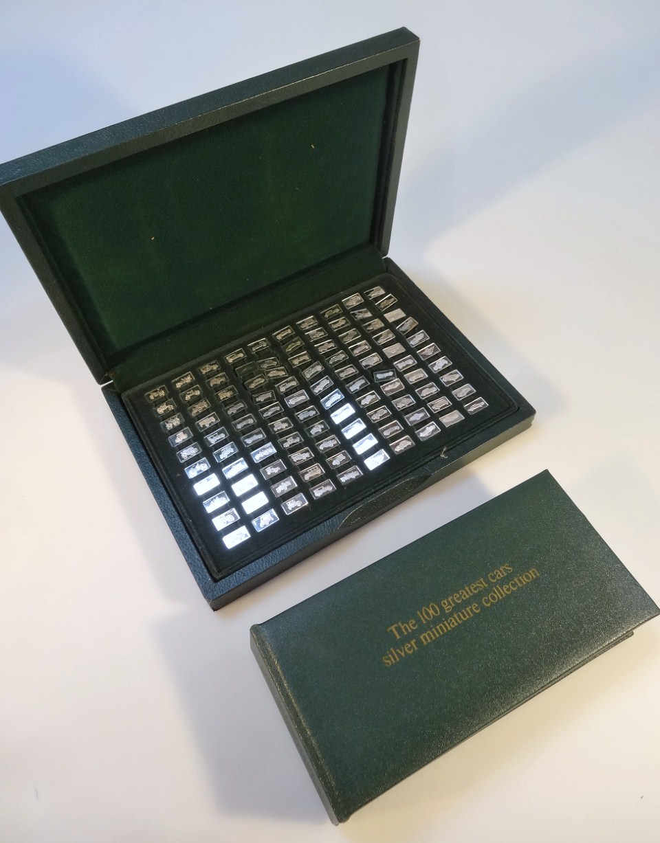 A John Pinches 100 Greatest car silver miniature ingot collection, in pressed green case, 27cm wide,