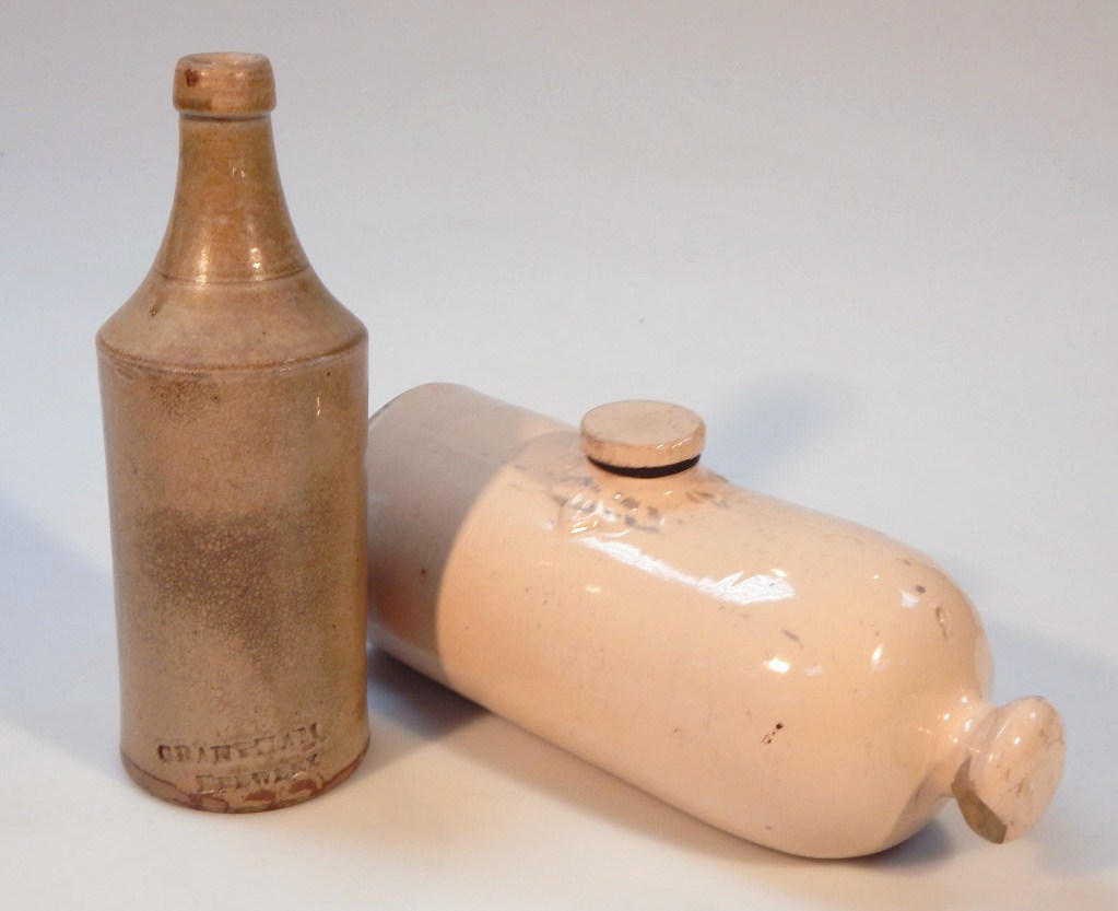 A Grantham brewery earthenware porter's style bottle, the cylindrical body with shouldered neck,