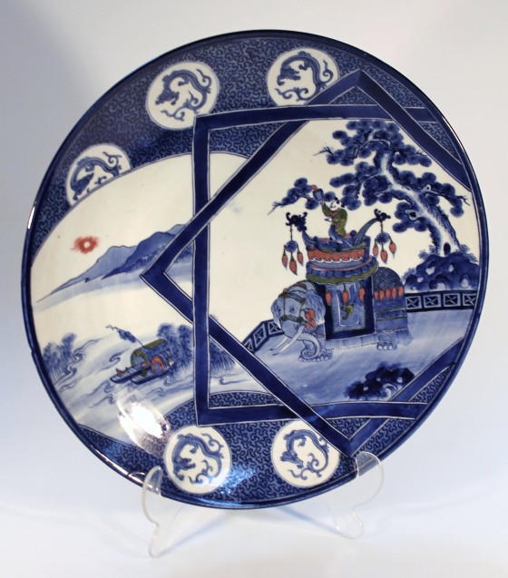 A 19thC Chinese porcelain charger, the circular dished body decorated with a figure on elephant