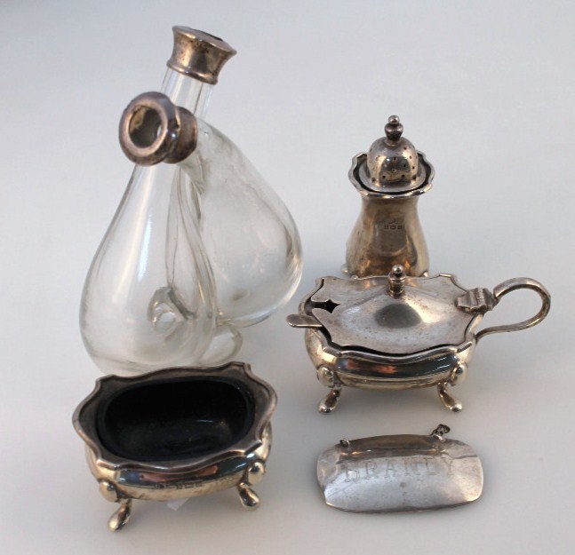 A Queen Elizabeth II silver cruet set, comprising open salt, lidded mustard jar and pepper pot,