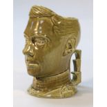 A mid-20thC Bretby style Edward VIII Coronation souvenir character jug, shoulder length in green,