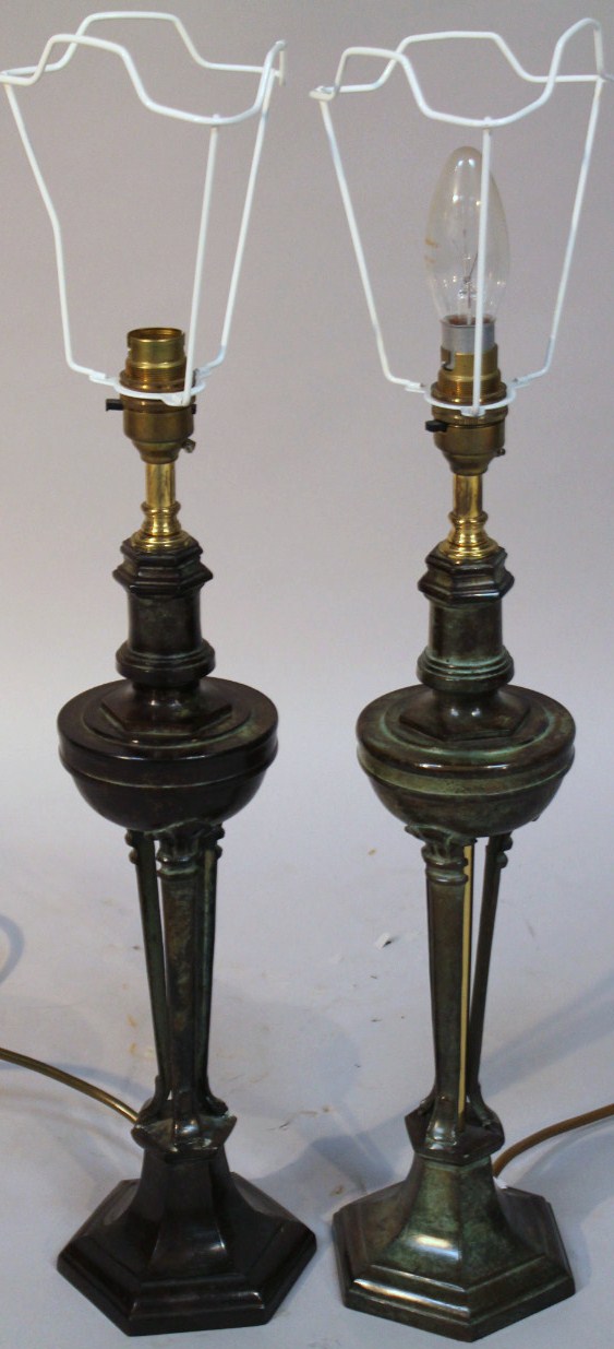 A pair of 20thC bronze finish metal table lamps, each with shaped circular stems on hexagonal feet