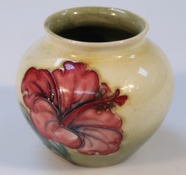 A mid-20thC Moorcroft Hibiscus pattern vase, the shouldered circular body with a yellow and green