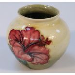 A mid-20thC Moorcroft Hibiscus pattern vase, the shouldered circular body with a yellow and green