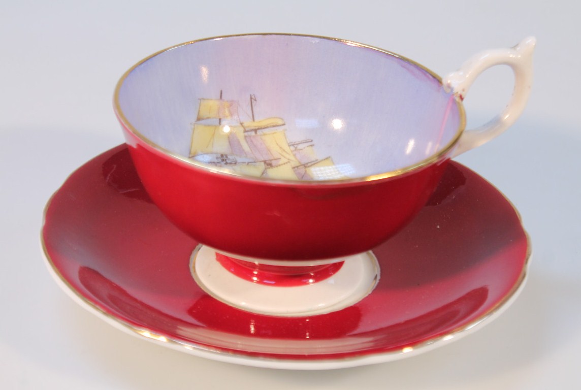 An Aynsley shipping cup and saucer, mainly decorated in brown with gilt highlights, printed marks