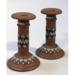 A pair of early 20thC Doulton Silicon candlesticks, each cylindrical body raised with a central