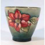 A 20thC Moorcroft Clematis pattern planter, decorated with flowers on green ground on circular foot,