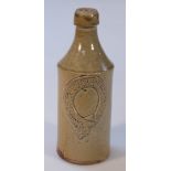 A London Stout Grantham porter's stoneware bottle, the shouldered cylindrical body with a raised