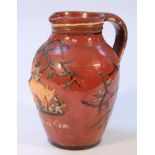 A 19thC American redware stoneware folk art jug, the bulbous body with moulded beak spout and