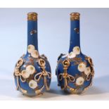 A pair of 20thC Japanese earthenware bottle vases and stoppers, each bulbous body raised with an