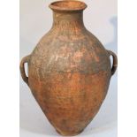 A 20thC baked earthenware Grecian style flagon, the bulbous body flanked by 'C' scroll handles on