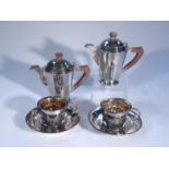 An early 20thC part tea service, comprising two water jugs, 17cm high, two cups and two saucers,