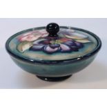 A mid-20thC Moorcroft Clematis pattern powder bowl and cover, on green ground, blue highlighted