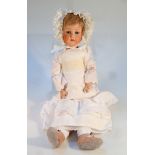 A late 19thC German Koppelsdorf bisque headed doll, with blonde hair, blink eyes and open mouth