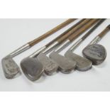 Six iron bladed hickory shaft golf clubs, (AF).