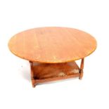 An oak circular coffee table, upon turned legs and rectangular base, 120cm dia.