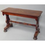 A Victorian mahogany side table, with central stretcher upon four circular feet, 124cm wide.