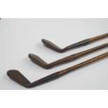 Three mid 20thC iron blade golf clubs, with hickory shafts, including Scottish Made, (AF).