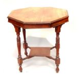 An Edwardian mahogany octagonal table, upon four reeded and turned legs with cross stretcher and