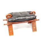 A mahogany and brass inlaid camel saddle, with leather cushion seat, 72cm wide.