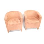 A pair of brown suede effect tub chairs.