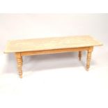 A pine scrub coffee table, with turned legs, 140cm wide.