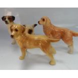 Three Coopercraft ceramic dogs.