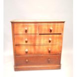 A Victorian mahogany chest of drawers, having two short over three long drawers with turned