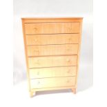 A tall Lebus beech chest of drawers, comprising six long drawers upon splayed feet, 76cm wide.