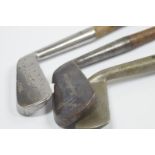 Three iron blade golf clubs, with hickory shafts, including J H Andrew, Wright & Dixon, and