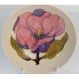 A Moorcroft pottery trinket dish, with yellow flower decoration, 12cm dia.