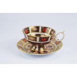 A Royal Crown Derby Old Imari 1128 pattern cabinet cup and saucer, and 1128 pattern saucer. (3).