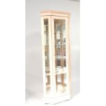 A washed beech glazed corner cabinet, with interior illuminated glass shelving, 205cm high.