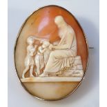 An oval shell cameo, raised with a profile of Jesus healing the sick, shaped yellow metal setting